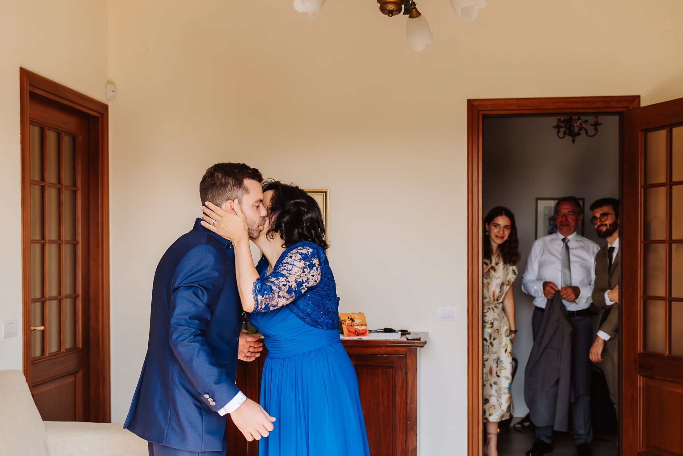 A series of wedding photos showing intimate moments between a couple in a blue dress and navy suit in a rustic venue.