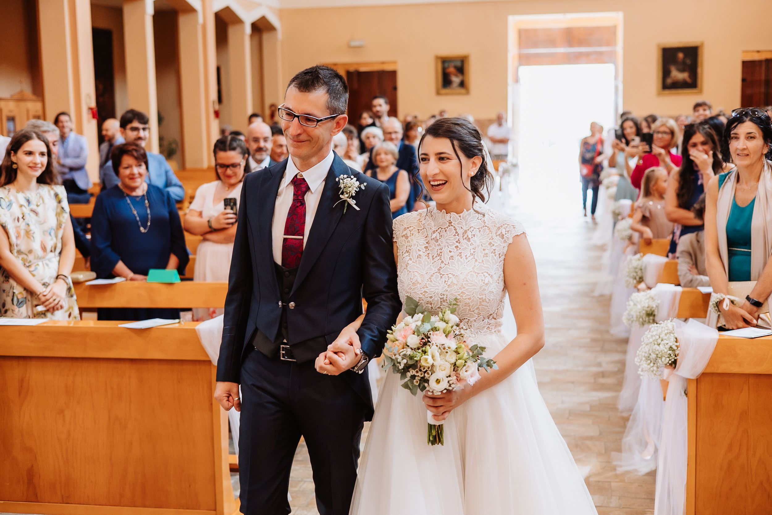 A wedding ceremony collage showing various moments from inside a church with guests and decorative elements.