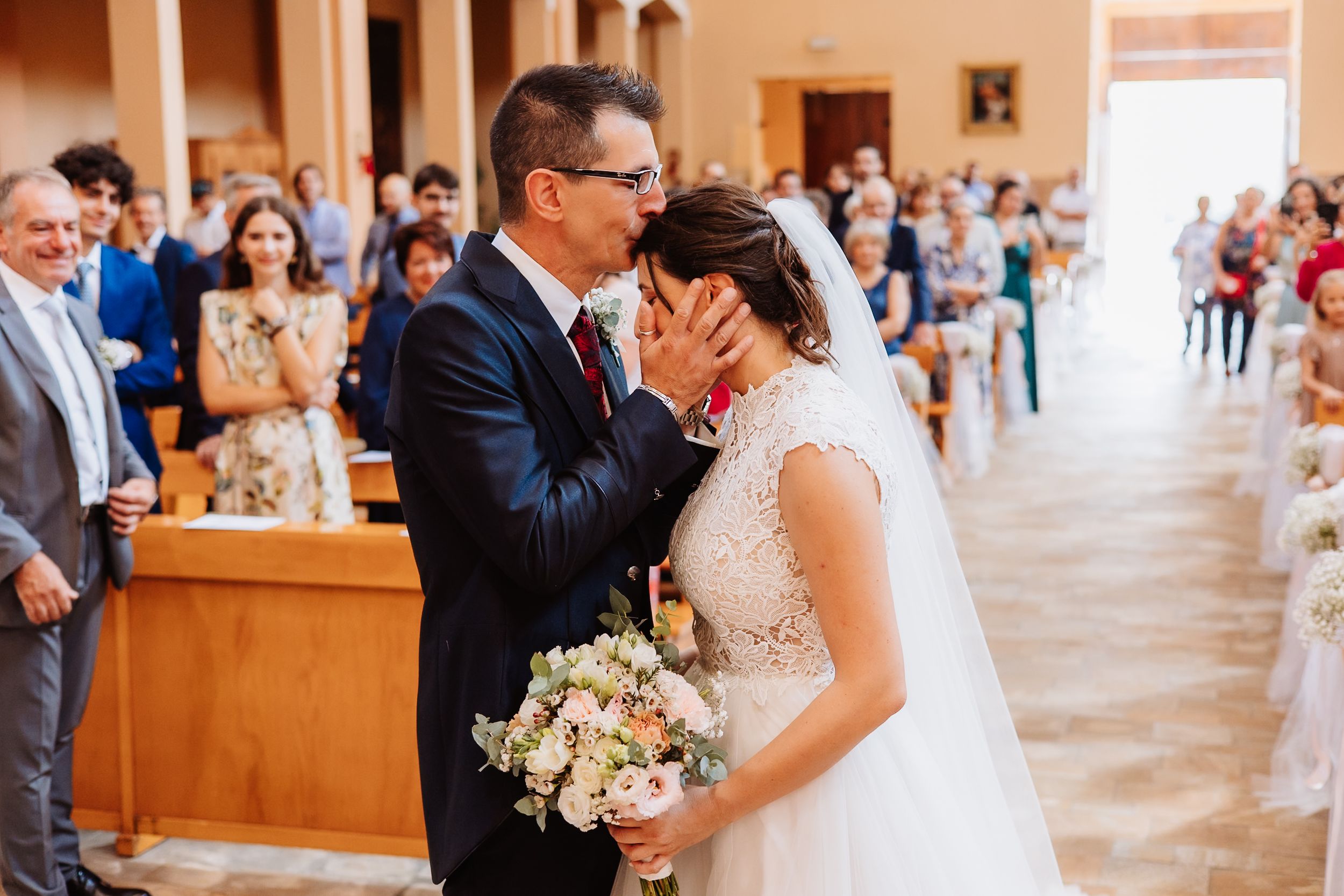 Collage of wedding ceremony moments showing couples embracing in a church with floral arrangements and guests in attendance.