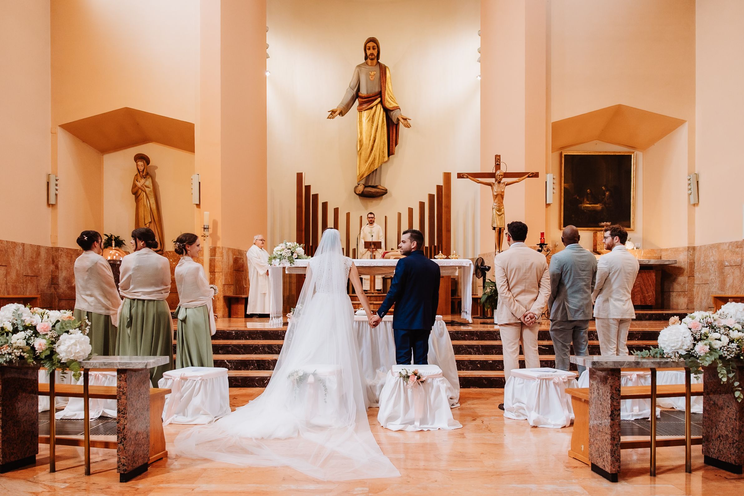 A wedding ceremony sequence showing a Catholic church interior with people gathered at the altar and pews.