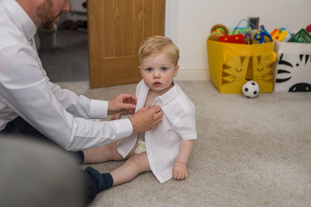 Living room floor with children's toys scattered near wooden furniture.