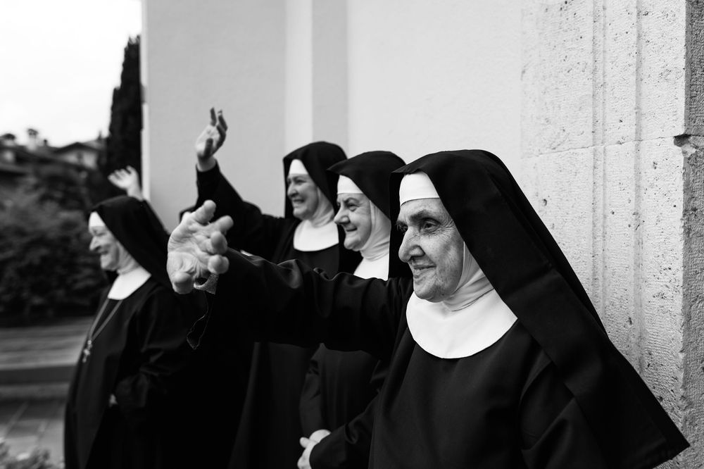 A collection of black and white photographs showing nuns in traditional habits standing together in various poses.