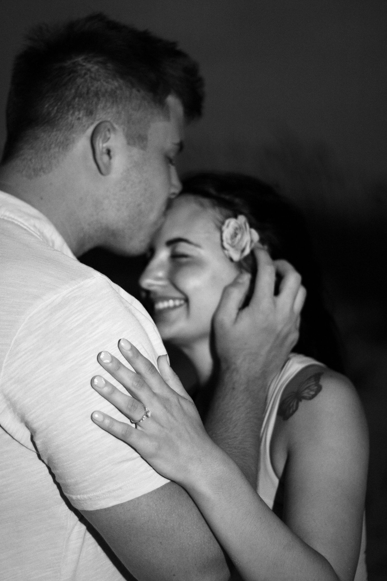 Intimate black and white photos showing tender moments between a couple.