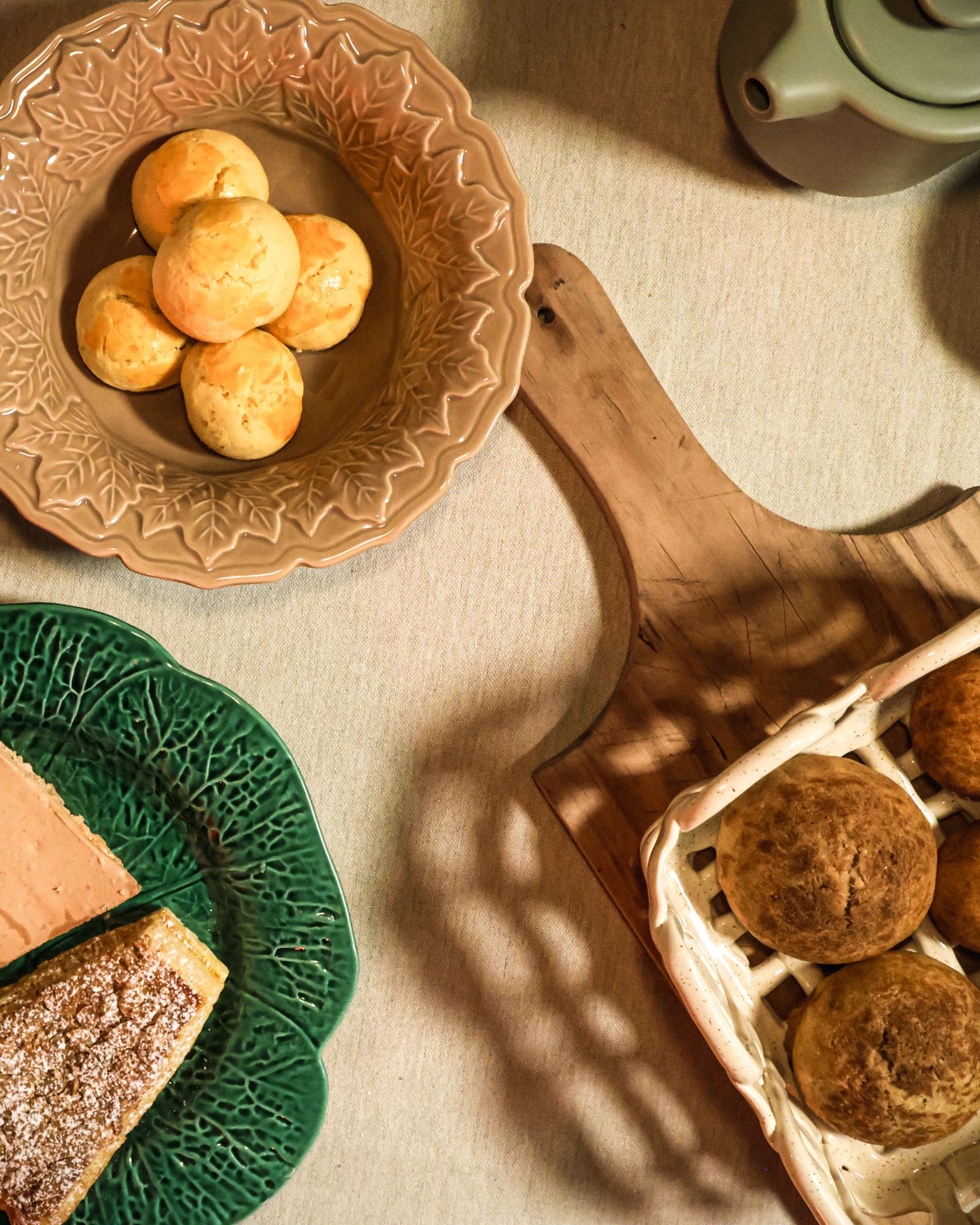 Artfully arranged food display with brown and green decorative plates.