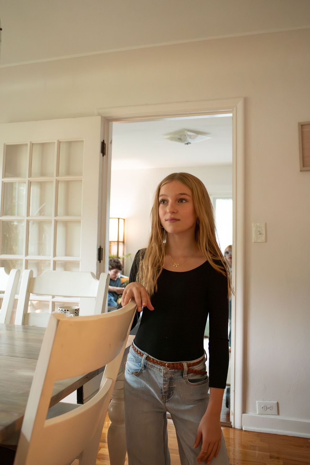 A preteen girl standing in her family dining room at home in Lansing, Michigan