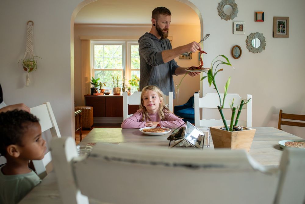 A dad serving his children brunch at home in Lansing, Michigan