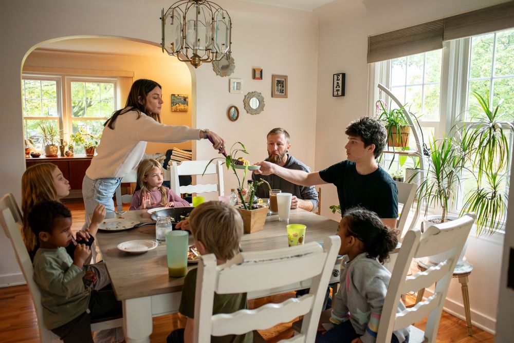 A mom serving her kids brunch at the family dining table in their home in Lansing, Michigan