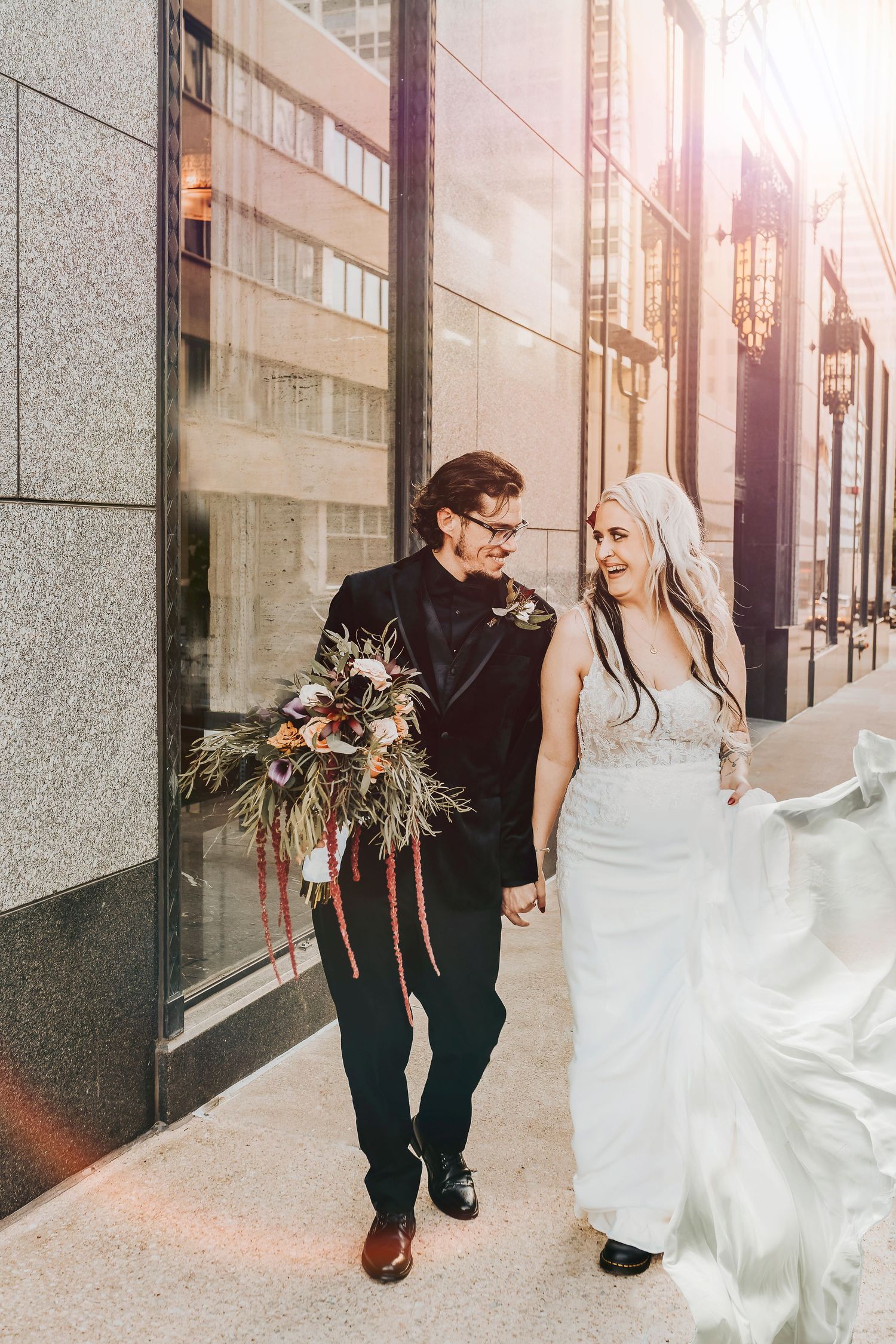 bride and groom taking formal photos in front of the carlisle room in dallas