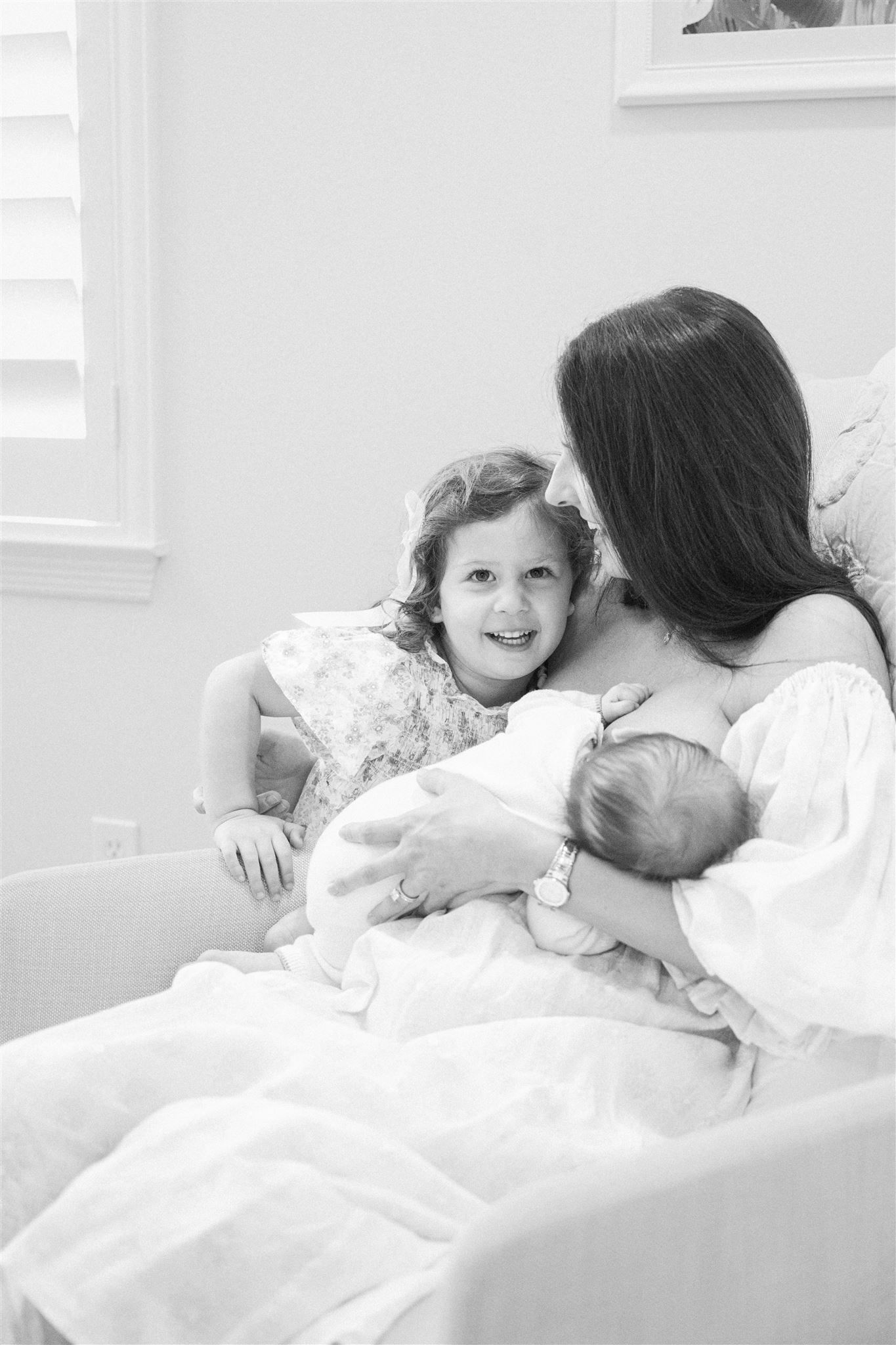 A sequence of monochromatic photos shows sweet parent-child bonding with hugs and laughter in bed.