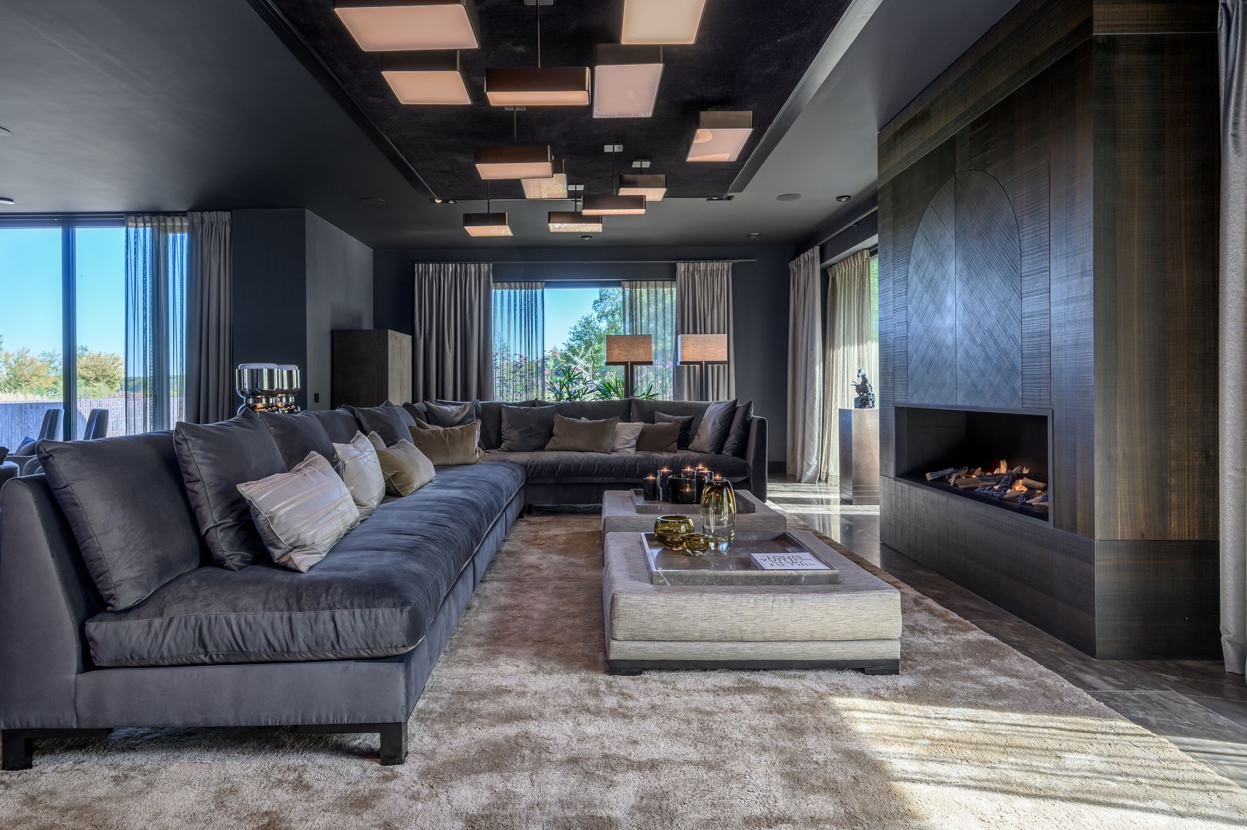 Elegant gray living area featuring modern furnishings and clean architectural lines in The Netherlands by Parallel Studios