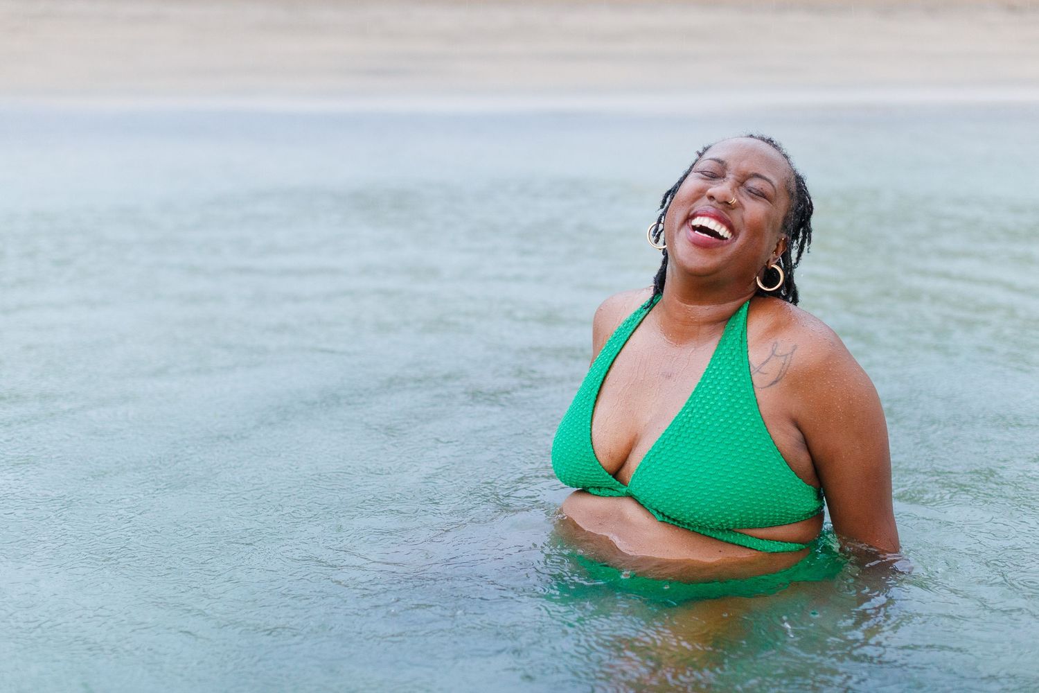 Portrait of a woman at the beach in the rain in Luquillo, Puerto Rico.