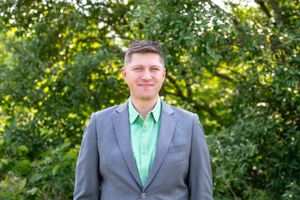 Outdoor headshot of man in Cincinnati with natural lighting and professional styling for high-end business and personal branding clients