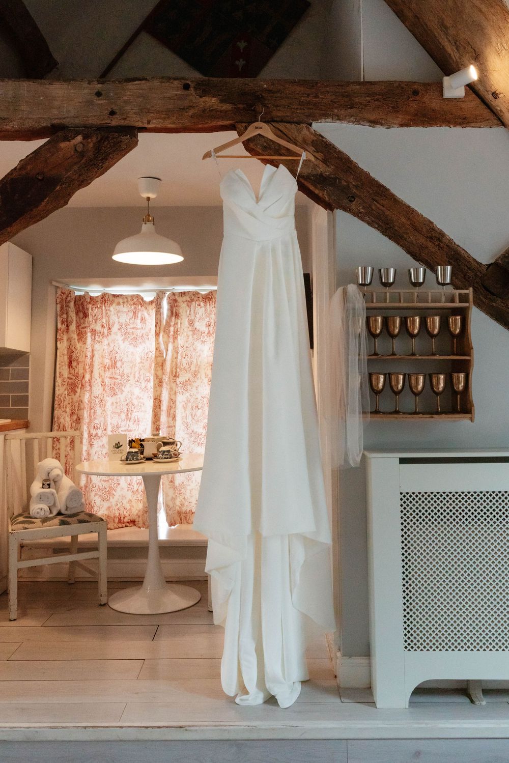 Owlpen Manor wedding photographer Zara Davis Photography Cotswolds Gloucestershire bride dress hanging in bedroom