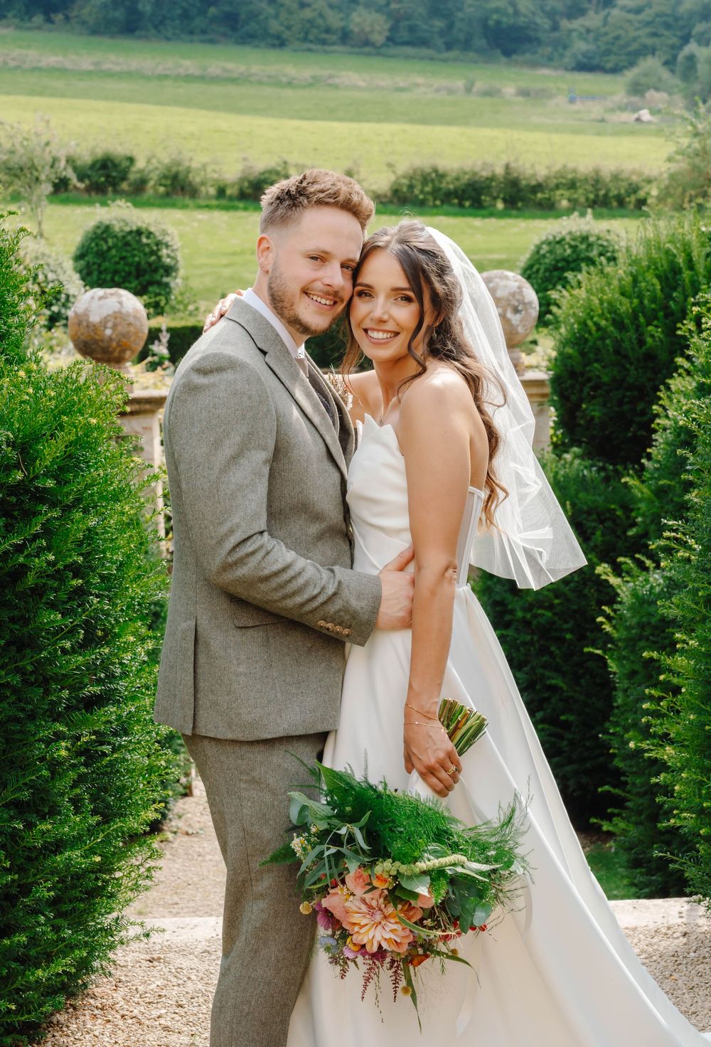 Owlpen Manor wedding photographer Zara Davis Photography Cotswolds Gloucestershire bride and groom portrait in garden