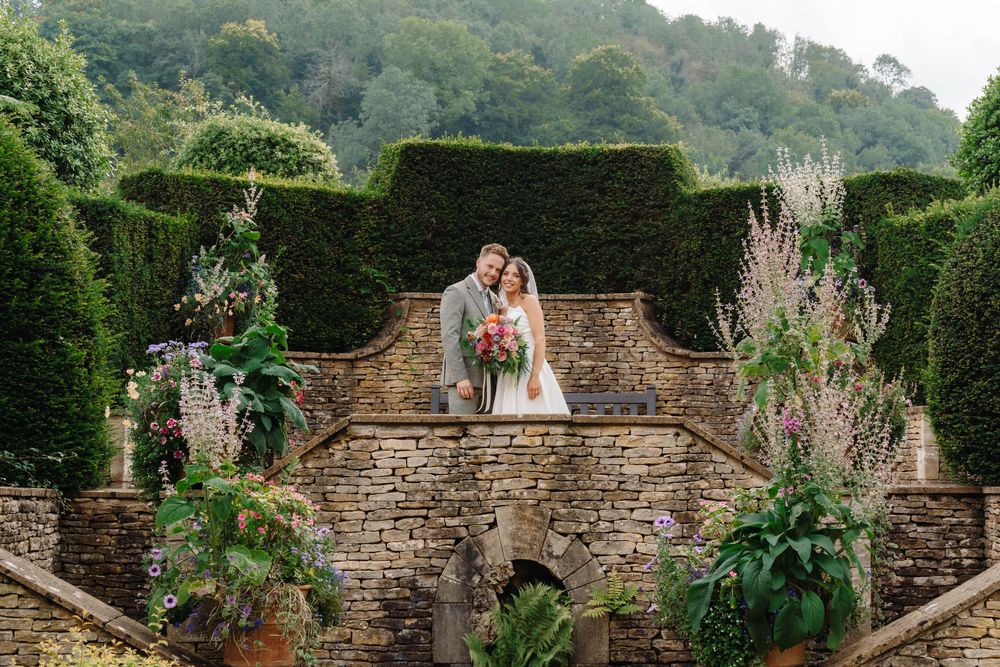 Owlpen Manor wedding photographer Zara Davis Photography Cotswolds Gloucestershire bride and groom on steps portrait