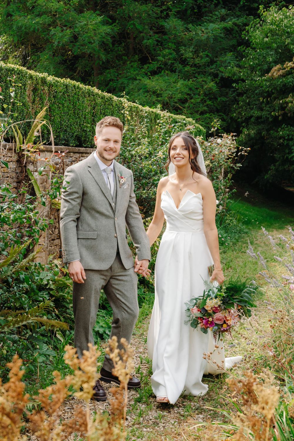 Owlpen Manor wedding photographer Zara Davis Photography Cotswolds Gloucestershire bride and groom portrait by stream