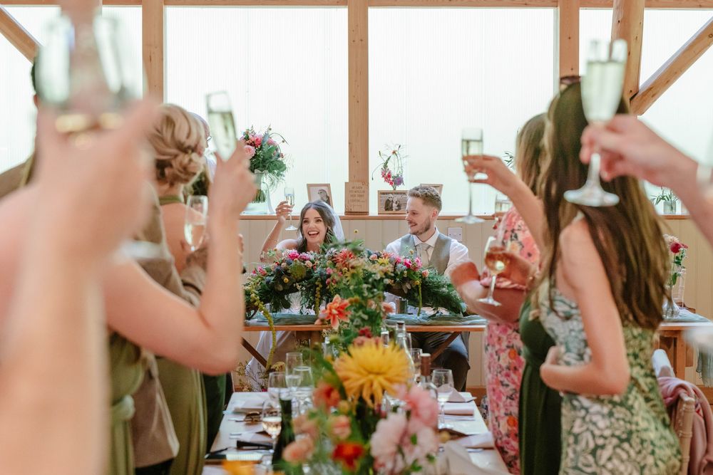Owlpen Manor wedding photographer Zara Davis Photography Cotswolds Gloucestershire bride and groom toast after speeches
