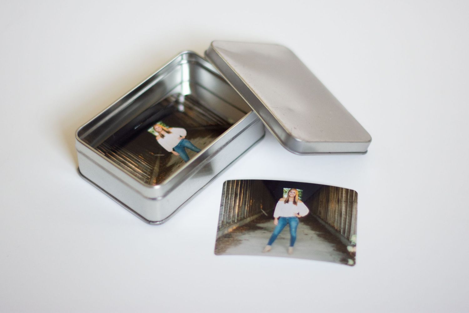 Metal photo storage boxes arranged in a minimalist layout on white background.