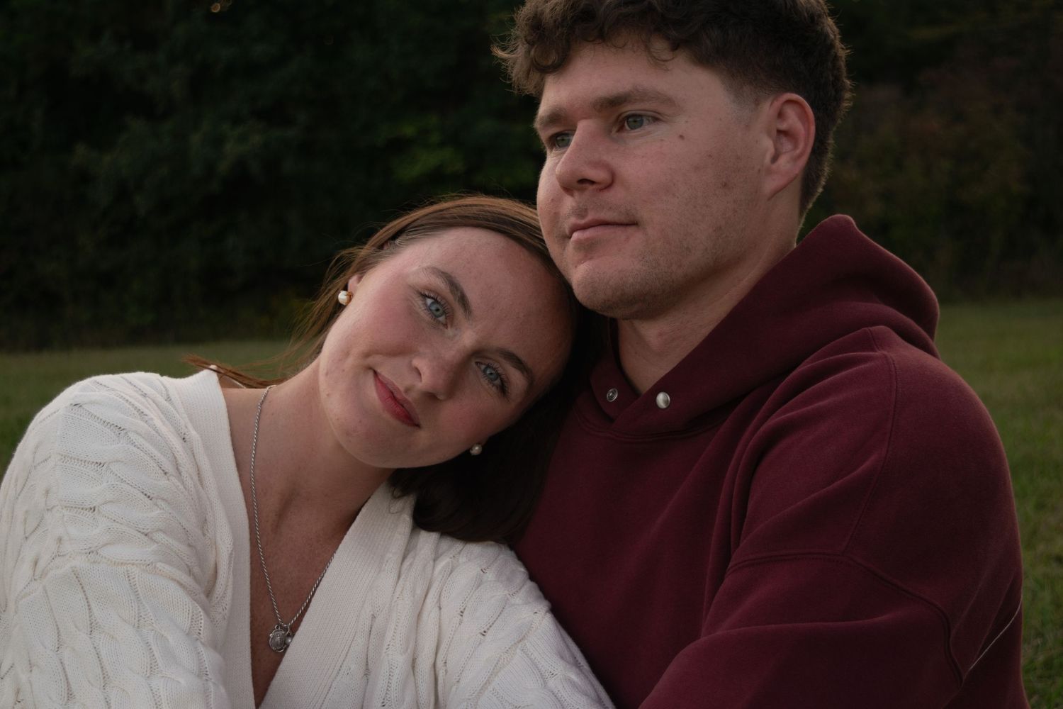 Woman resting her head on boyfriend's shoulder while smiling