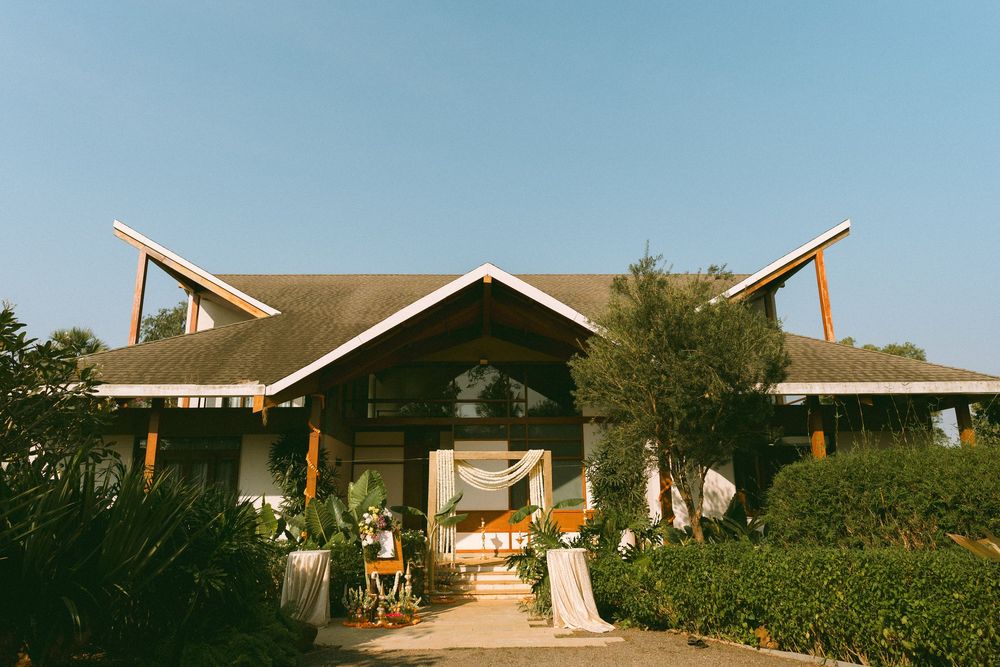 Panoramic view of modern ranch-style houses with sloped roofs against a sunny sky.