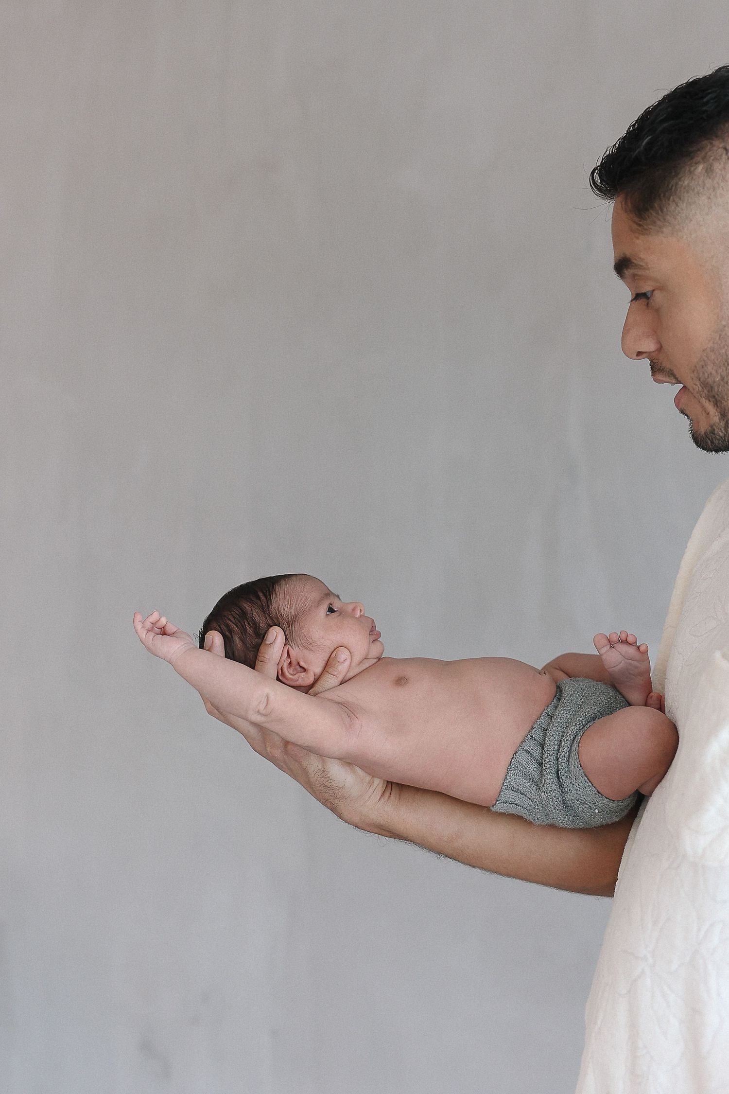 Candid family newborn photography of newborn and dad in Spark Studio Huntington Beach, California