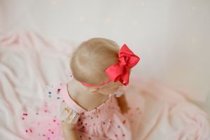 Red paint or frosting creates an artistic splatter effect on a light colored background, forming abstract patterns.