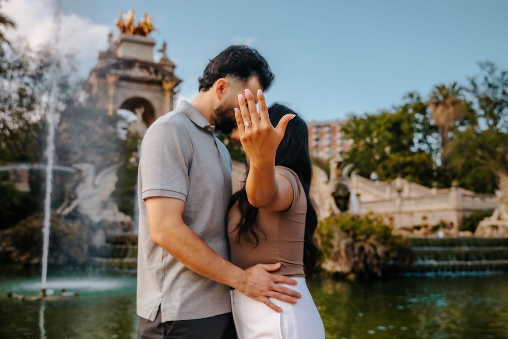 Couple smiling with joy after their surprise engagement.
