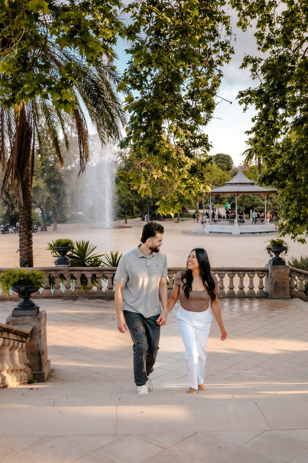 Couple walking hand in hand after saying yes in Barcelona.