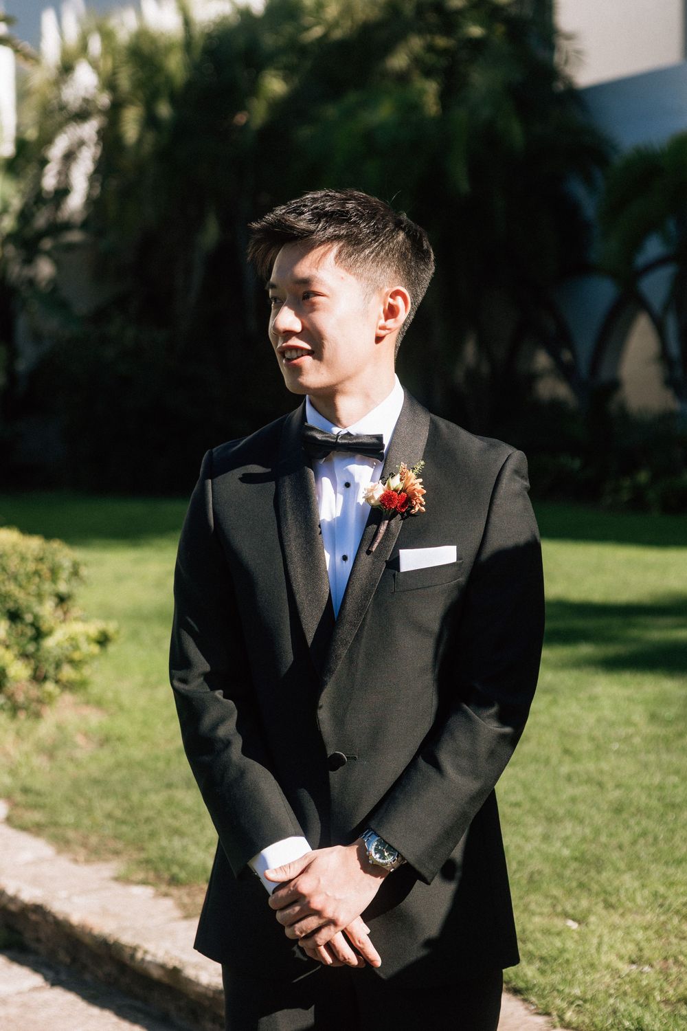 A groom watches his bride come down the aisle before his micro wedding at the Santa Barbara Courthouse Sunken Gardens.