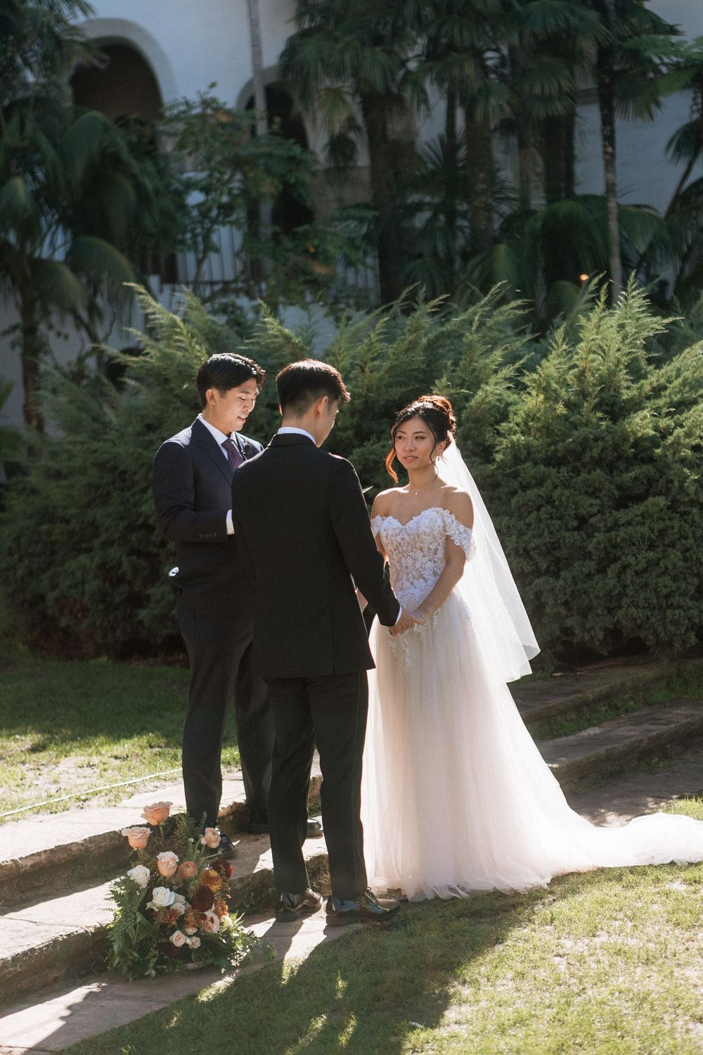 A bride and groom exchange vows at their Santa Barbara Courthouse wedding ceremony at the Sunken Gardens