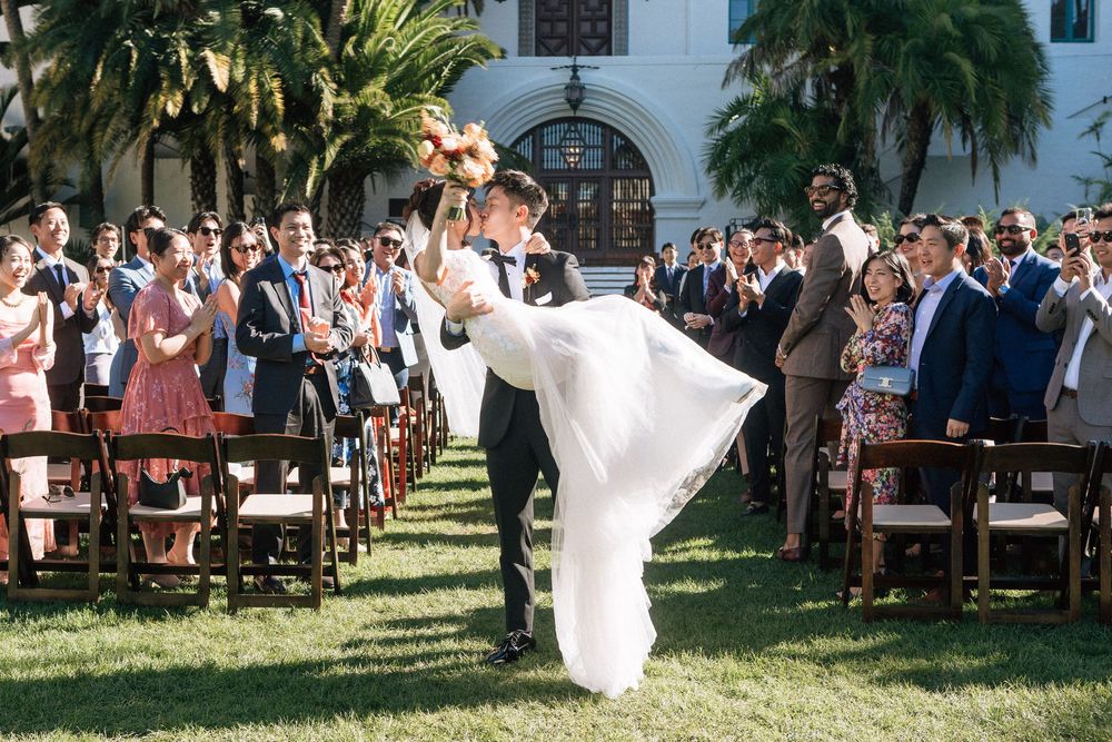 Santa Barbara photographer captures a bride being lifted in the air following a micro wedding at the Santa Barbara Courthouse
