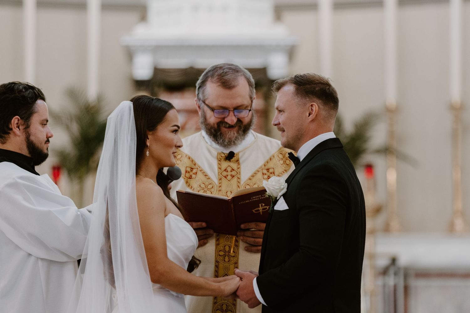 Bride and groom exchanging wedding rings at Sacred Heart Cathedral, Knoxville wedding photography