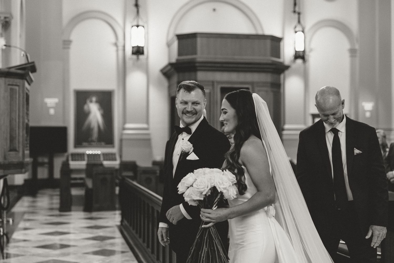 Groom watching bride walk down aisle at Sacred Heart Cathedral Knoxville, TN wedding photography by Allie Krauser Digtals