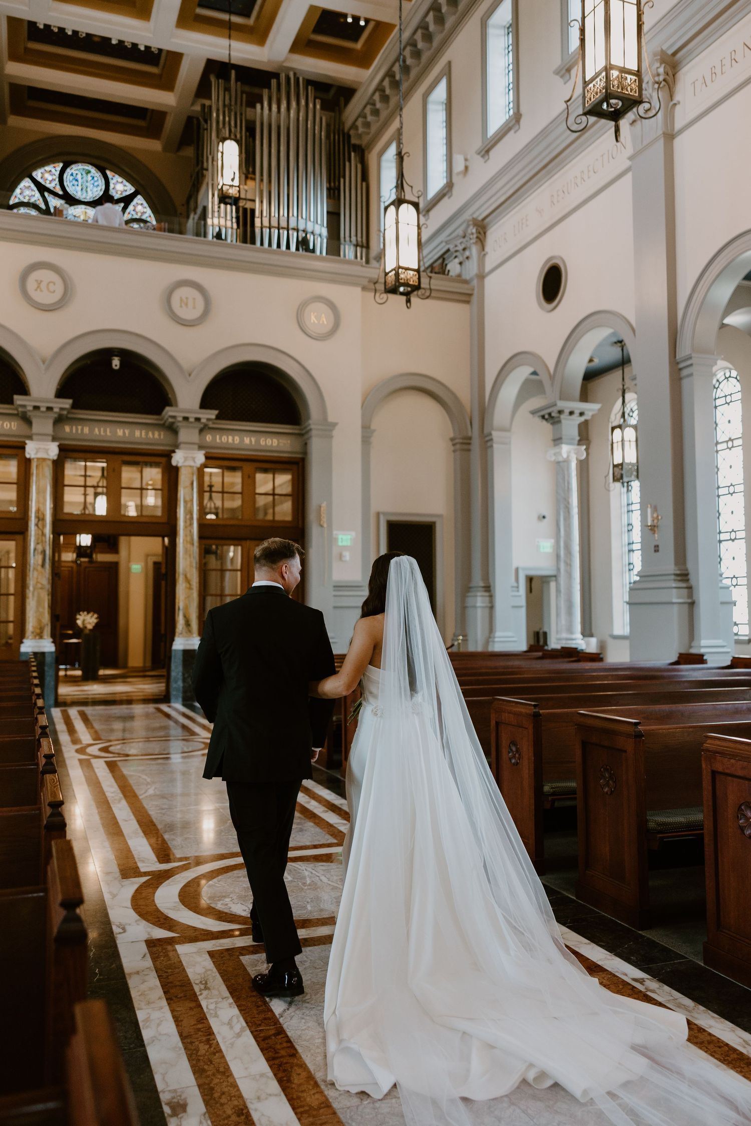 Bride walking down aisle with groom after ceremony is over at the Sacred Heart Cathedral, Knoxville TN wedding photographer
