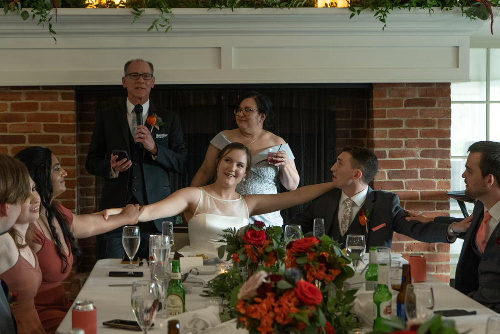 Wedding guests laugh and celebrate together at a reception dinner in Nationwide Conference Center