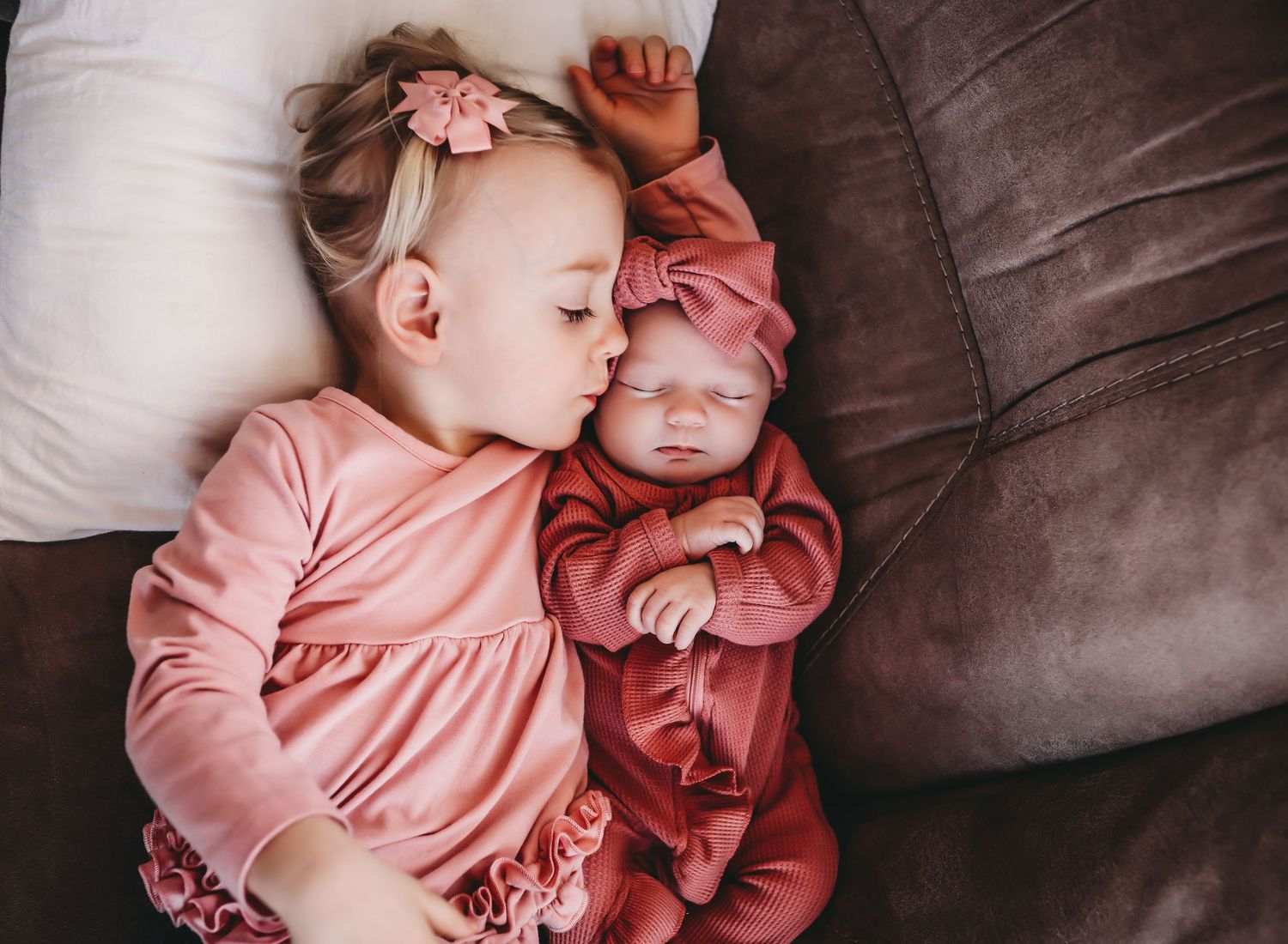 A heartwarming series of five connected photos showing tender moments between two people in pink outfits on a couch.