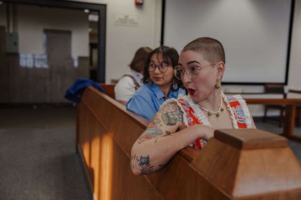 Couple shares casual moments in church meeting room.