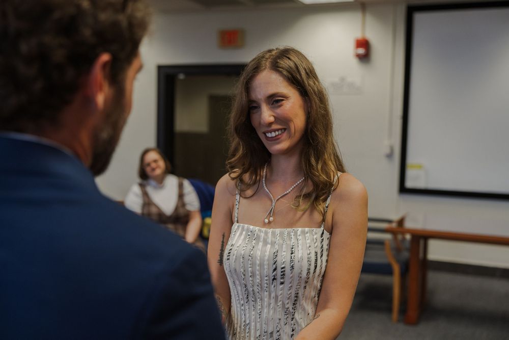 A couple shares a tender moment during their courthouse wedding ceremony.