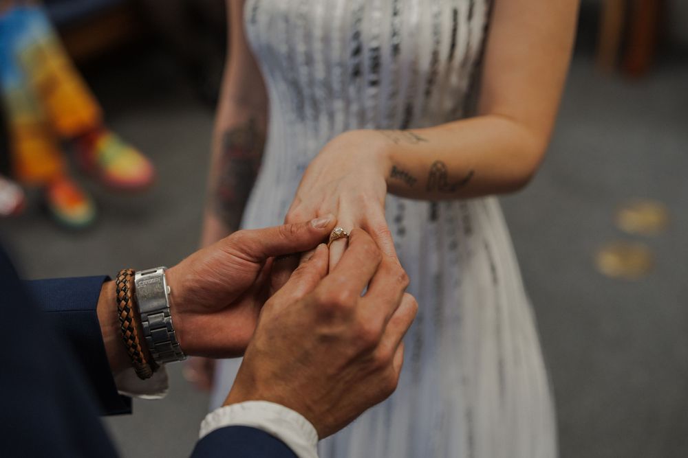 Hands clasped together during an intimate wedding ceremony moment.