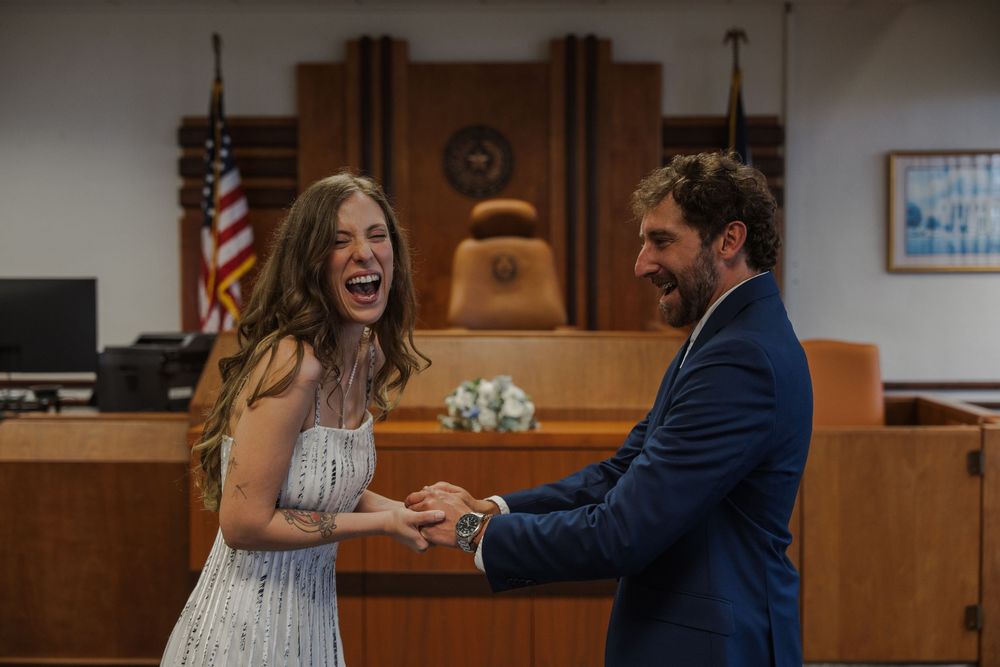 Couple celebrates their first moments as newlyweds in a courthouse setting.