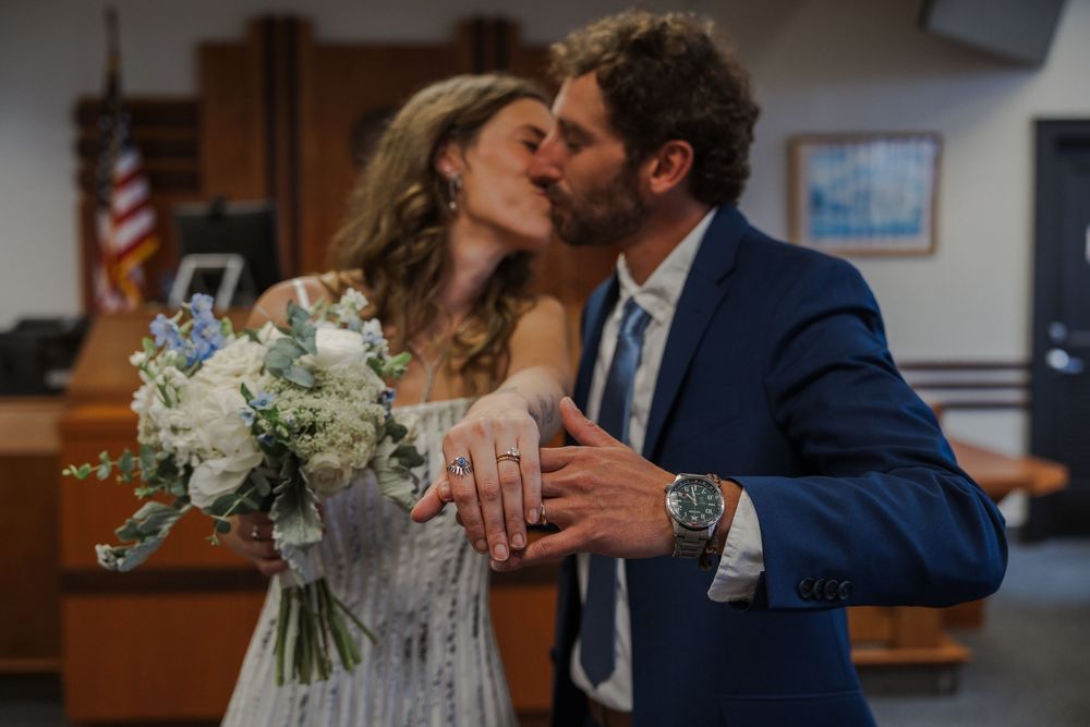 Romantic moment shared between newlyweds after their courthouse ceremony.