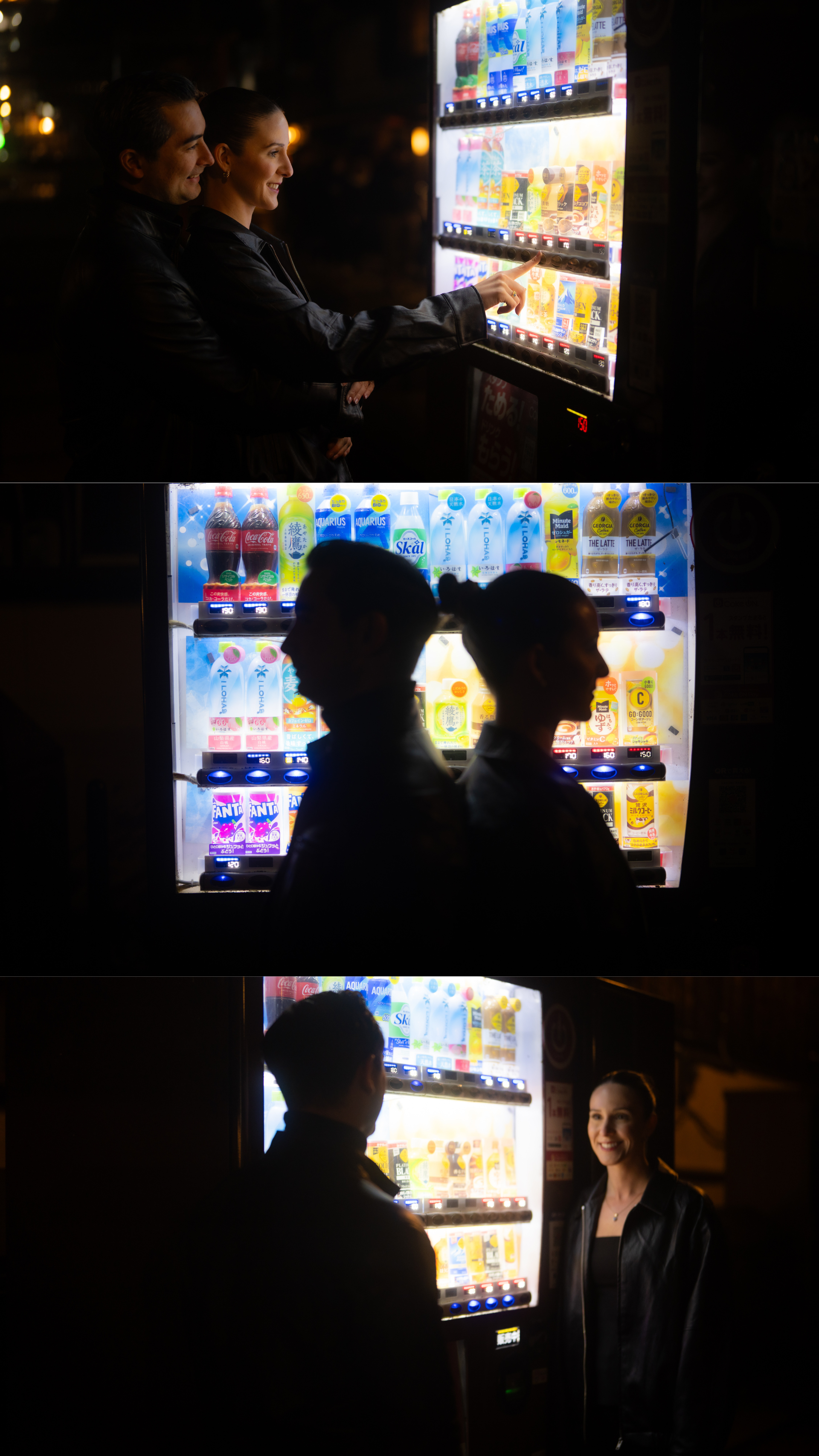 A couple selects drinks from a brightly lit Japanese vending machine in a dark nighttime setting.