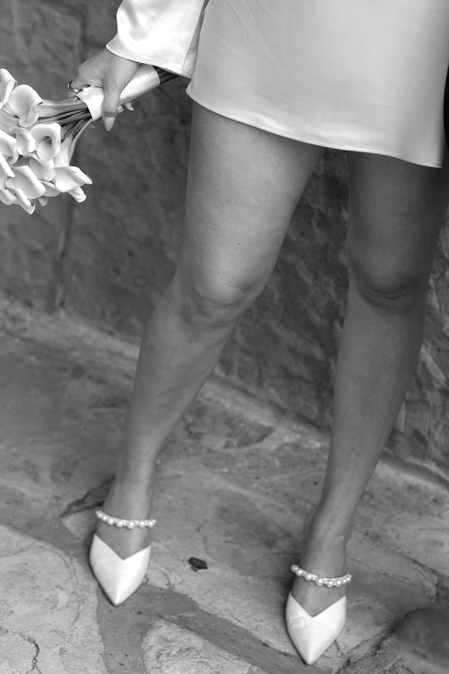 A sequence of black and white photos showing legs wearing white shoes and an ankle bracelet.
