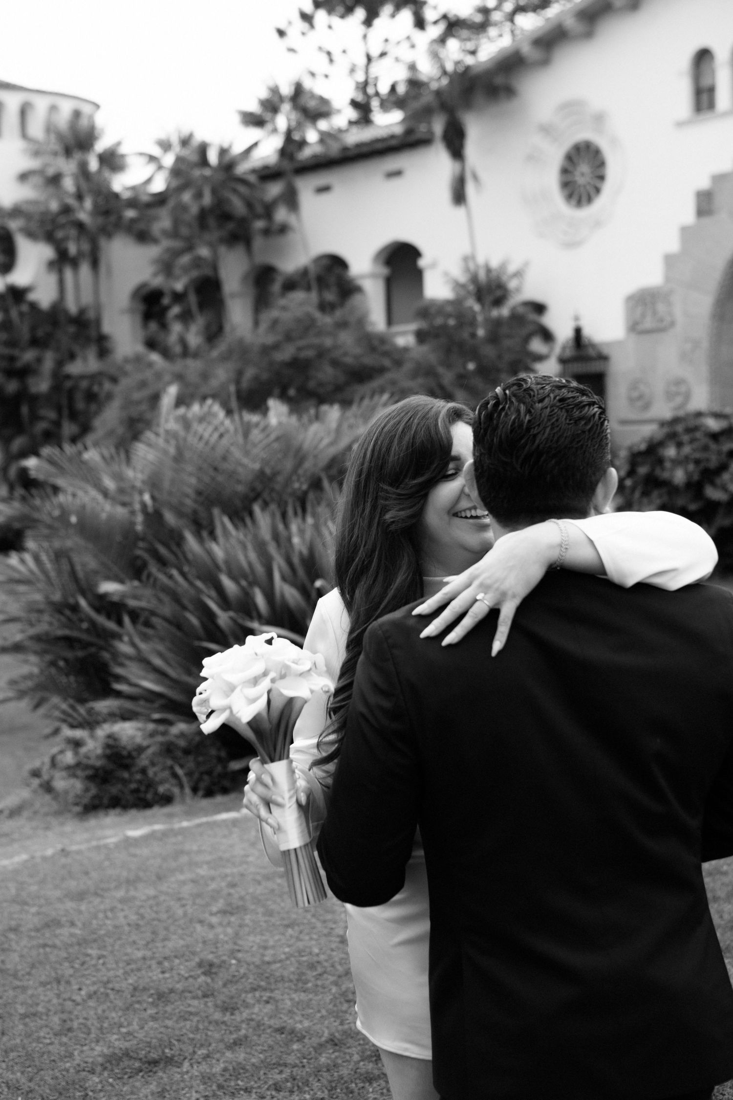 A romantic black and white photo sequence shows a couple embracing and spinning together on a grassy lawn.