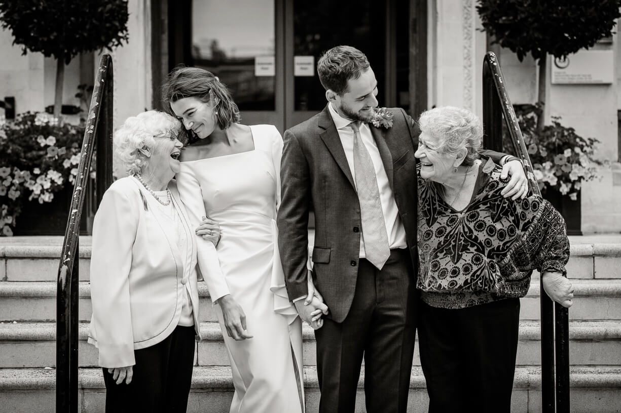 A black and white wedding photo collage showing intimate moments between a couple throughout their special day.