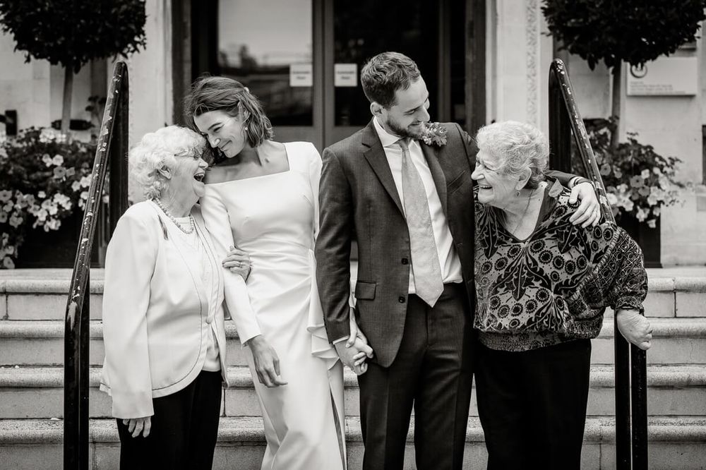 A black and white wedding photo collage showing intimate moments between a couple throughout their special day.