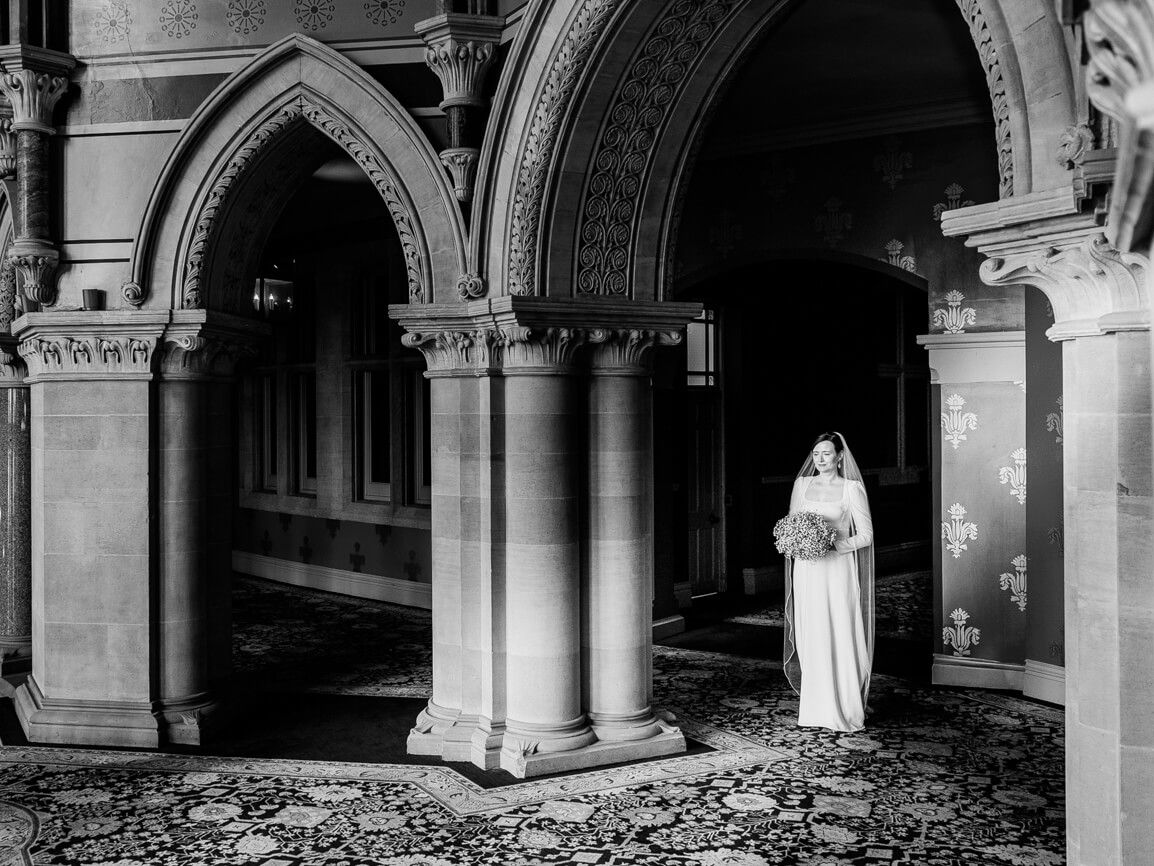 Gothic stone archways and columns create elegant architectural details in a historic building.