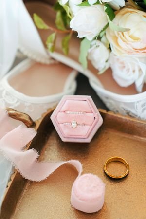 Wedding details with wedding rings, heels, ribbon, and flower bouquet at The Magnolia Estate Rosewood Manor: Cincinnati Wedding Photographer