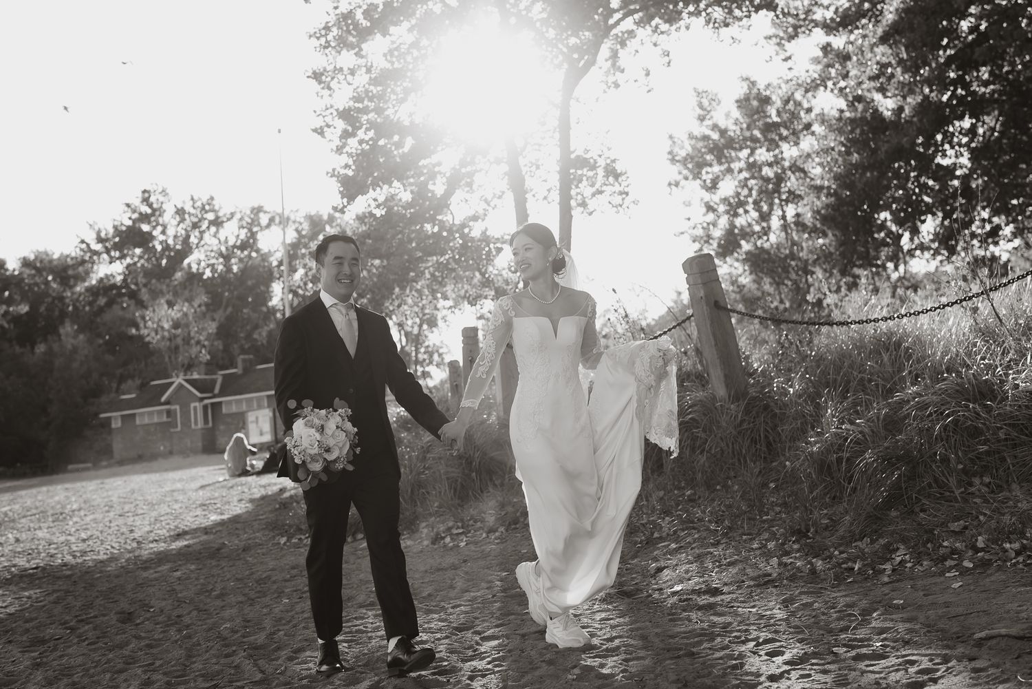 Backlit black and white candid photo of the couple in a natural setting, captured with genuine emotion by Toronto wedding photographer.