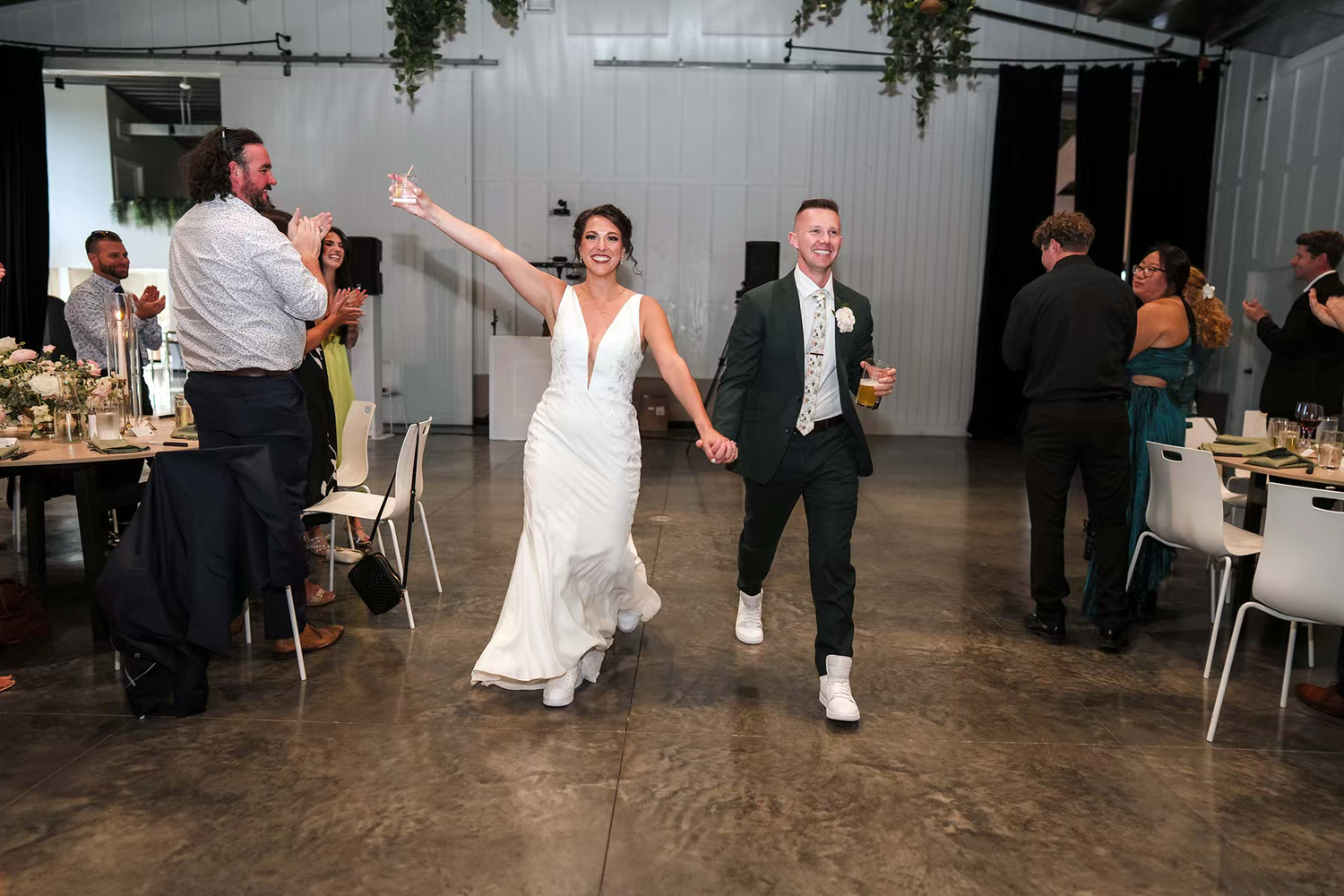 first entrance of a couple celebrate during a lively wedding reception in Retreat 21 Wedding Venue
